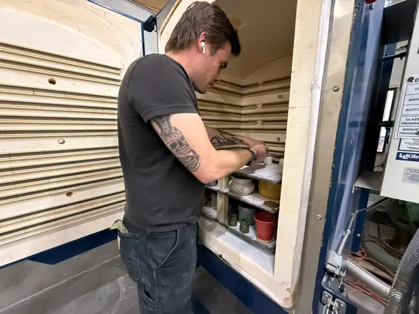 Loading Pottery Into Kiln Shelves