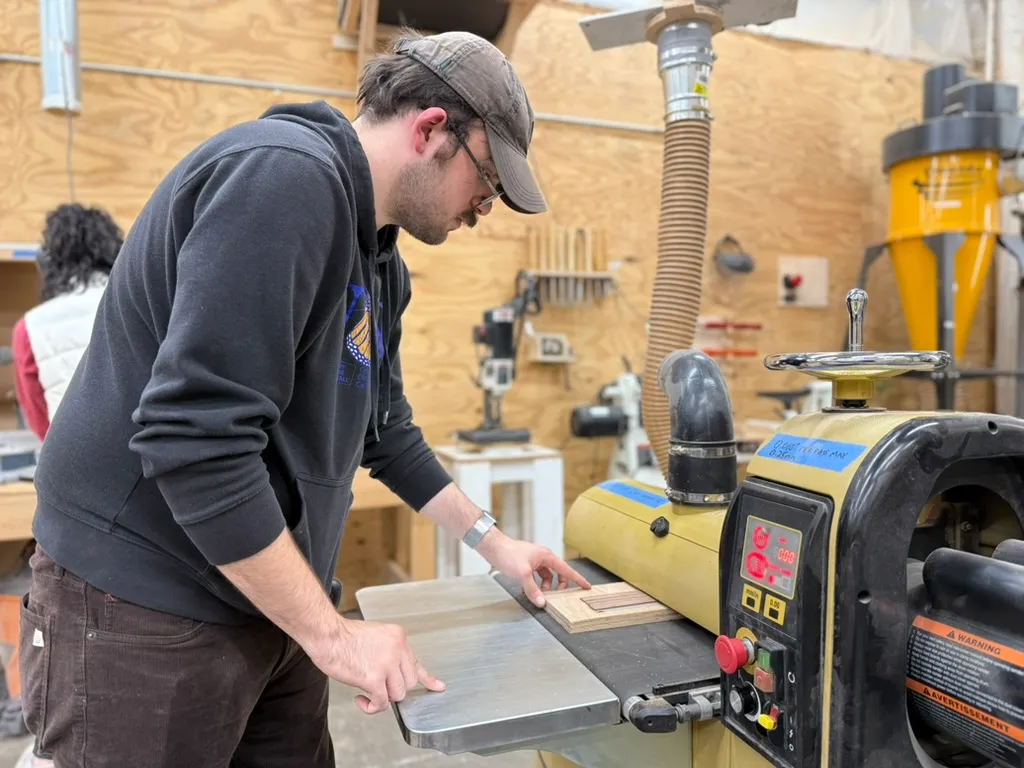 Man In Cap Operating Drum Sander