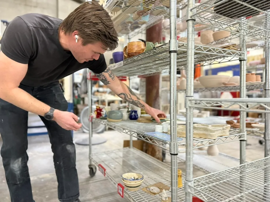 Inspecting Pottery On Studio Drying Racks