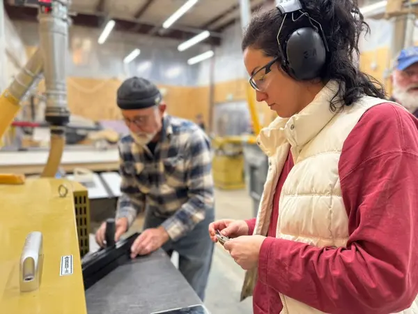 Two Woodworkers Inspecting Jointer Blade